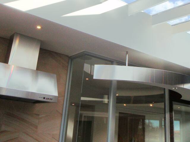Open-plan kitchen. Ceiling, bulkheads and walls in a modern kitchen.