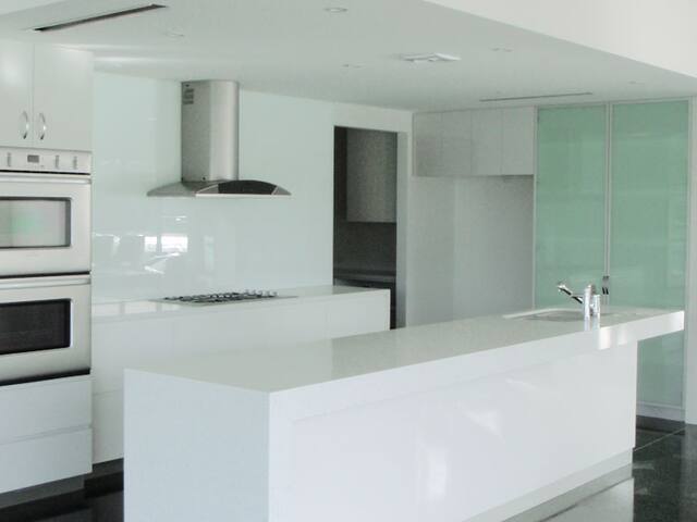 A bright white kitchen with freshly painted walls and ceiling