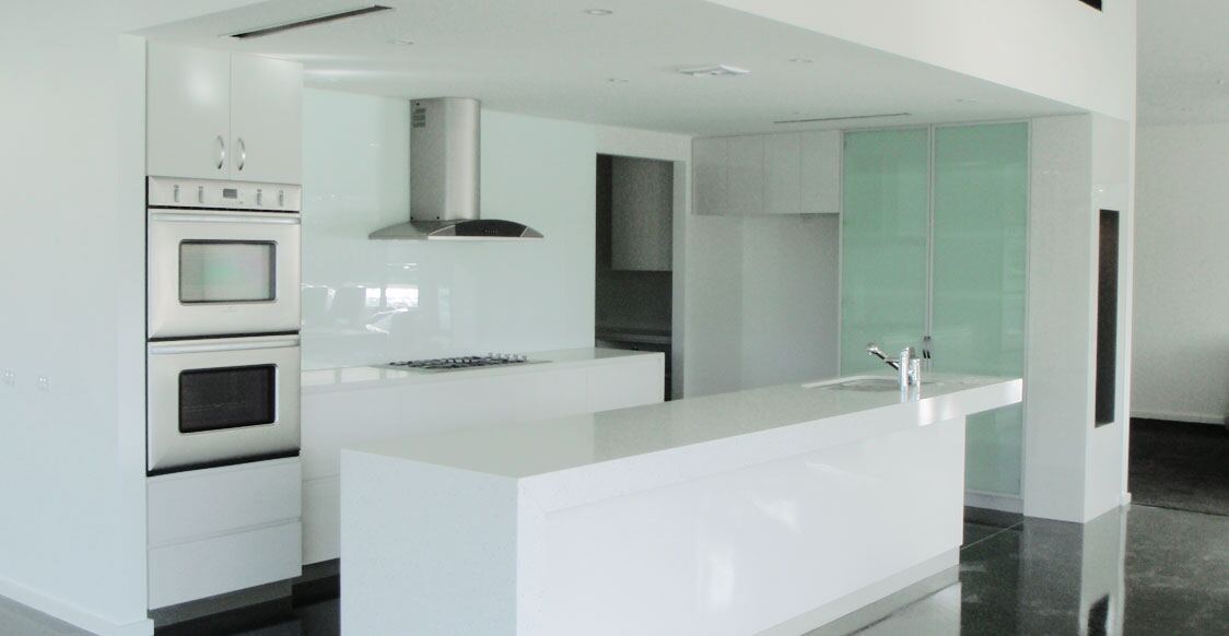 A bright white kitchen with freshly painted walls and ceiling