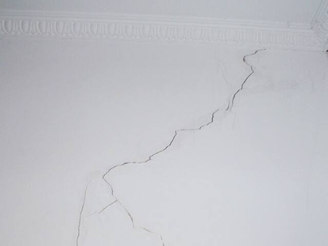 Ceiling crack before repair. Cracks like this are opened up, filled and sanded before any paint goes on.
