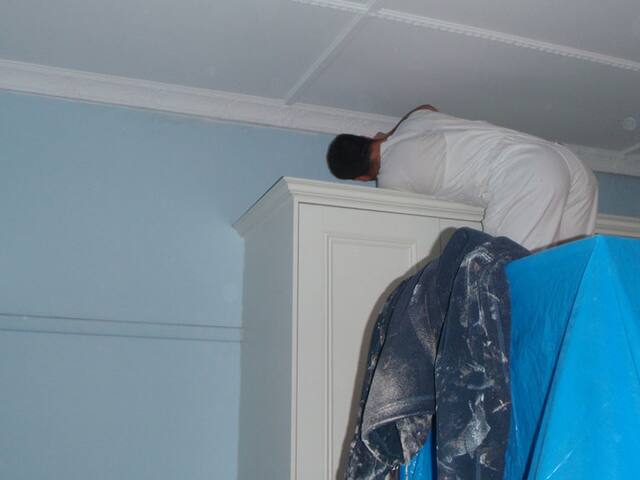 Protecting the room. Furniture and floors covered before work starts.
