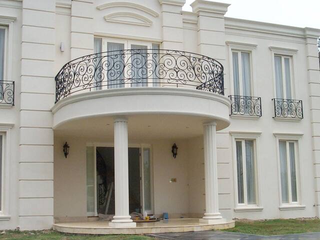 Balcony and balustrade detail. Ironwork and render detail finished on the front elevation.