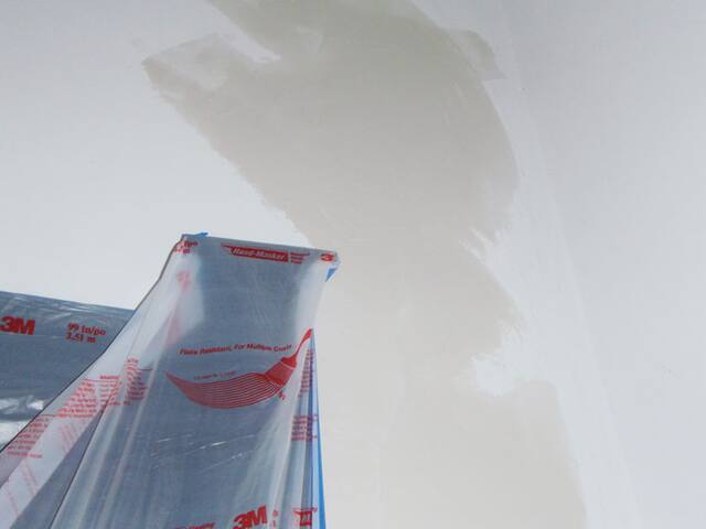 Masking before spraying. Windows and surfaces masked off for a clean spray finish.