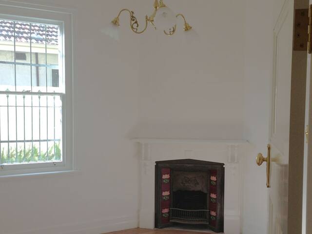 Period bedroom and fireplace. Walls, ceiling and mantel in a period home.