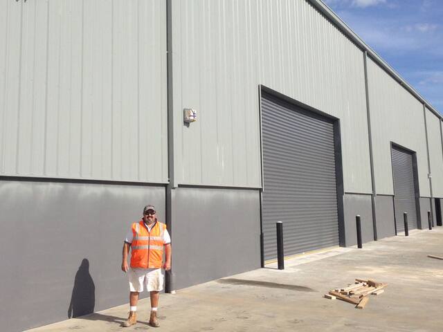 Warehouse exterior. Cladding and roller doors on an industrial unit.