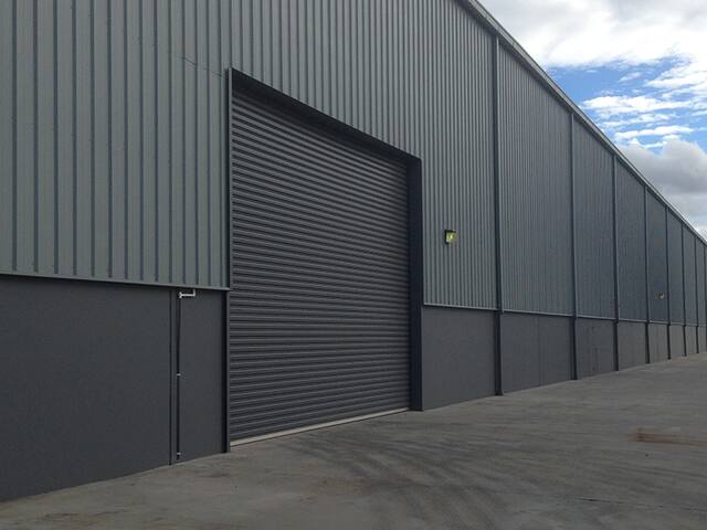 Completed warehouse. Industrial units finished in a two-tone scheme.