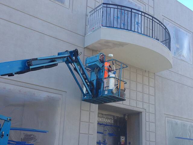 Apartment building exterior. High-access exterior repaint on an apartment block.